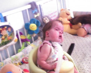 Mandy sitting up in her little chair